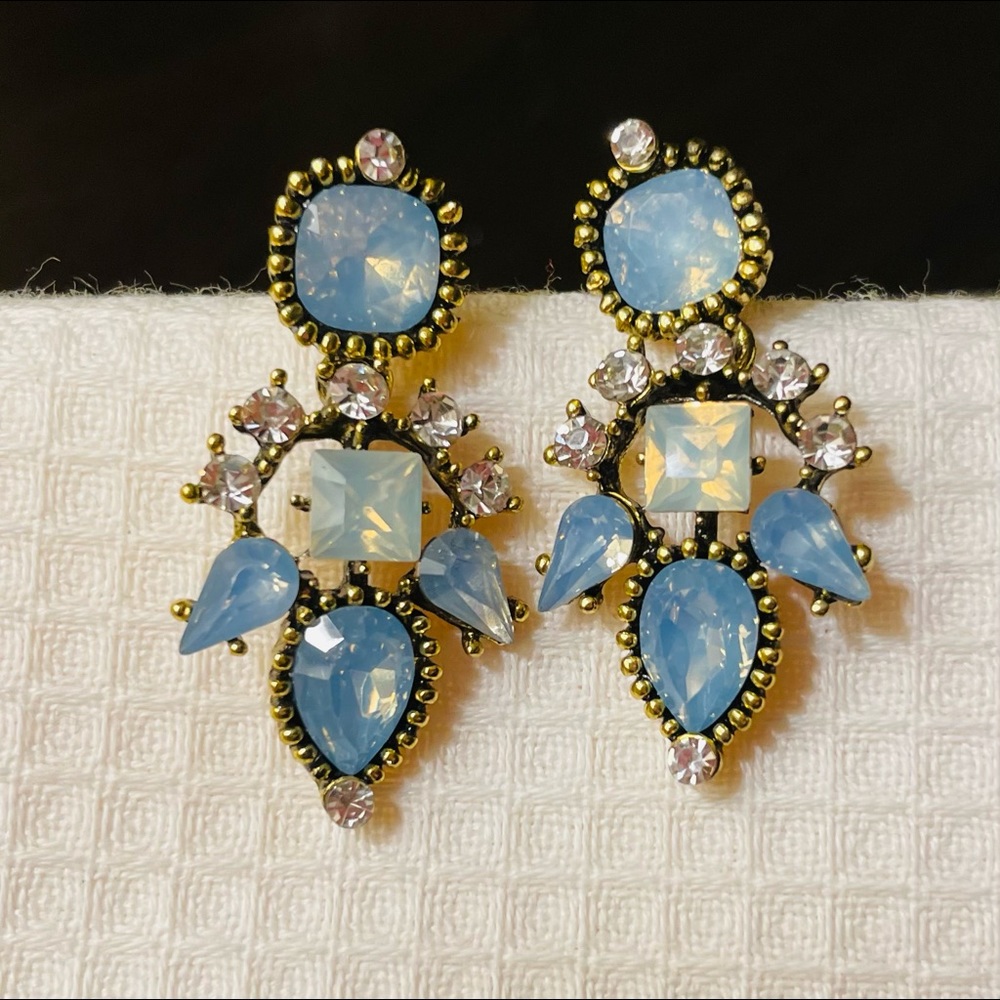 Light blue dangling earrings with stones. Gold accent